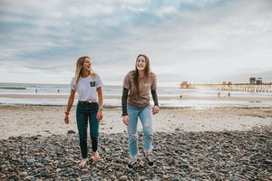 Two women laughing at the beach wearing reef safe sunscreen